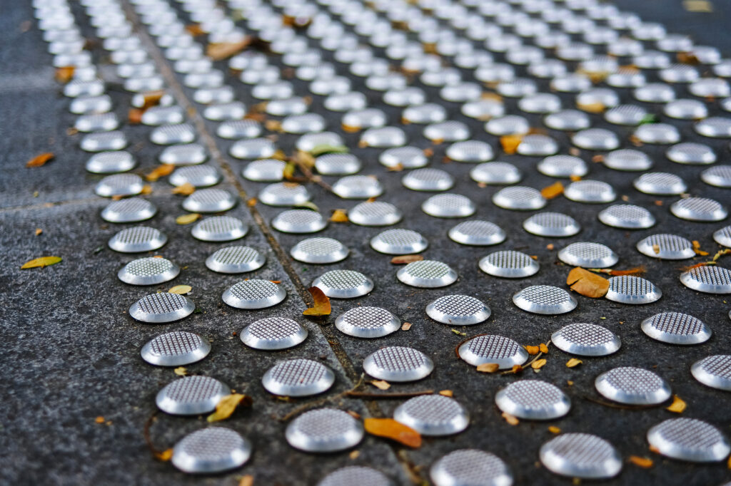Metal tactile paving tiles for the blind. Care for the disabled